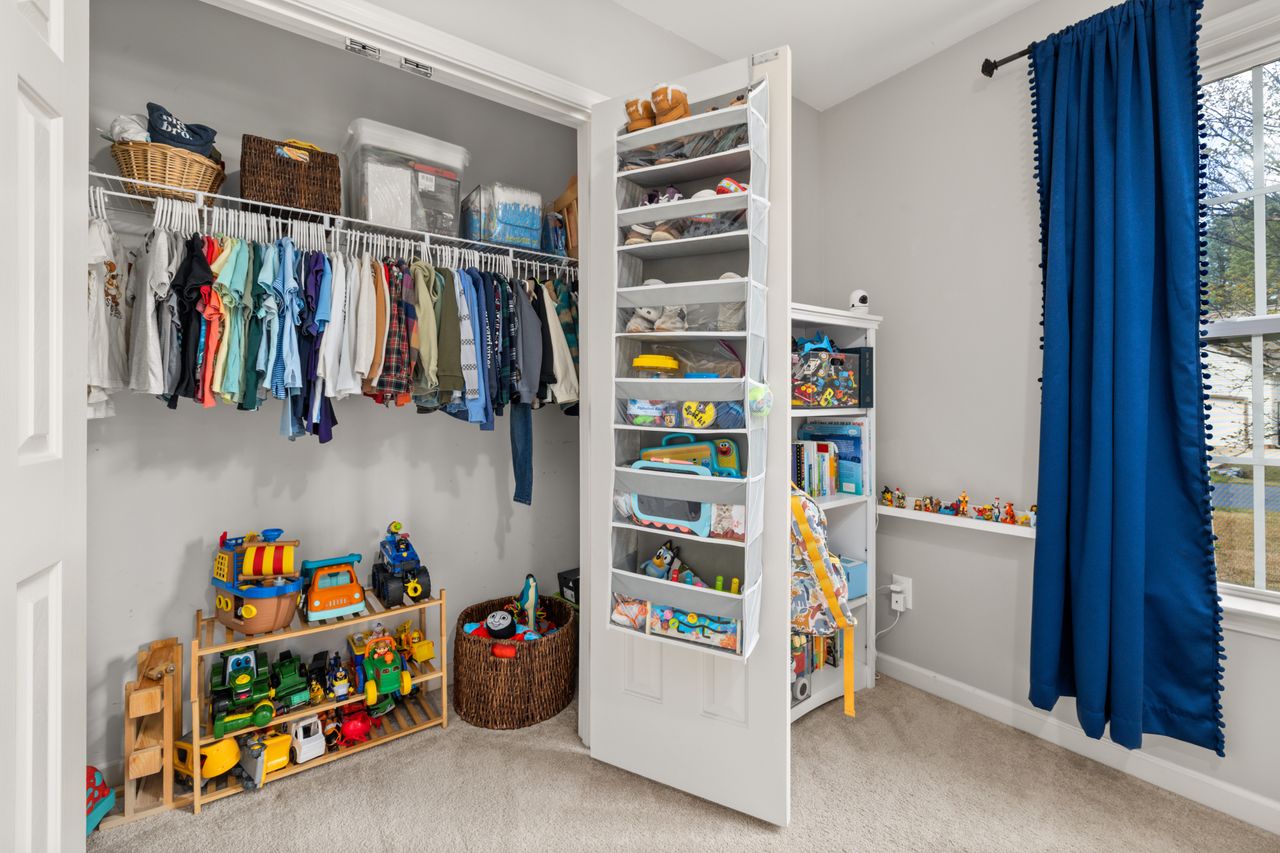 services-01 A neatly organized childrens closet featuring clothes, toys, and storage solutions.